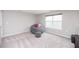 Inviting bedroom featuring a cozy beanbag chair, stool, and a window for natural light at 237 Begen St, Morrisville, NC 27560
