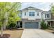 Inviting two-story home featuring a grey two-car garage and stone accents on the facade at 237 Begen St, Morrisville, NC 27560