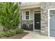 Cozy front porch with chairs, stone pillars, and well-maintained landscaping at 237 Begen St, Morrisville, NC 27560