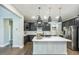 Spacious kitchen featuring an island with white quartz countertops and modern pendant lighting at 237 Begen St, Morrisville, NC 27560