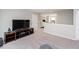 Open living room area with plush carpet, a large television, and neutral walls at 237 Begen St, Morrisville, NC 27560
