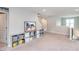 Open-concept living space with neutral carpet, ample natural light and decorative shelving and accents at 237 Begen St, Morrisville, NC 27560