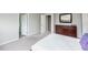 Bedroom featuring plush neutral carpet and an ensuite bathroom with a dual-sink vanity and a walk-in shower at 237 Begen St, Morrisville, NC 27560