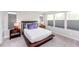Comfortable bedroom with natural light, wood bed frame, and side tables with stylish lamps at 237 Begen St, Morrisville, NC 27560