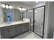 Modern bathroom featuring double vanity and glass enclosed shower with marble-style tile at 2401 Whitewing Ln, Wendell, NC 27591