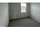 Clean bedroom with neutral carpet and a window view of the neighborhood at 2401 Whitewing Ln, Wendell, NC 27591