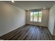 Bright bedroom with wood flooring and large window providing natural light at 2401 Whitewing Ln, Wendell, NC 27591