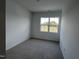 Bright bedroom with neutral carpet and a view from the window at 2401 Whitewing Ln, Wendell, NC 27591