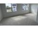 Spacious bedroom with plush carpeting and two windows offering ample natural light at 2401 Whitewing Ln, Wendell, NC 27591