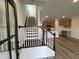 Inviting entryway with staircase and view of the modern kitchen and light wood flooring at 2401 Whitewing Ln, Wendell, NC 27591