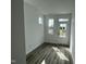Bright entryway with wood flooring, a white door and 3 windows providing natural light at 2401 Whitewing Ln, Wendell, NC 27591