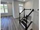 Inviting entryway with staircase and wood flooring leading to the front door at 2401 Whitewing Ln, Wendell, NC 27591