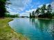 Beautiful pond featuring fountain and lakeside vegetation at 2401 Whitewing Ln, Wendell, NC 27591