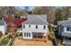 Rear exterior view of a home with light gray siding and a wooden deck under construction at 2605 Hazelwood Dr, Raleigh, NC 27608