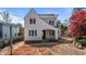 Charming two-story home featuring light-colored siding, black trim windows, and an inviting covered entryway at 2605 Hazelwood Dr, Raleigh, NC 27608