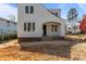 Charming two-story home featuring light-colored siding, black trim windows, and an inviting covered entryway at 2605 Hazelwood Dr, Raleigh, NC 27608