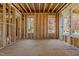 Unfinished interior showcasing exposed wood framing, creating a sense of spaciousness and potential at 2605 Hazelwood Dr, Raleigh, NC 27608