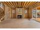 Unfinished living room space featuring fireplace, stairs, and backyard sliding door, ready for personalization and design choices at 2605 Hazelwood Dr, Raleigh, NC 27608