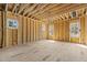 Room during construction featuring wooden framing, window, and open ceiling at 2605 Hazelwood Dr, Raleigh, NC 27608