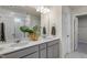 Bathroom featuring double sinks with a white countertop and elegant gray cabinetry with brushed nickel hardware at 279 Providence Creek Dr, Fuquay Varina, NC 27526
