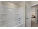 Clean and bright bathroom with a new shower, white walls, and an open doorway to the rest of the home at 279 Providence Creek Dr, Fuquay Varina, NC 27526