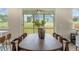 Dining room with large wooden table and chairs, and sliding glass doors to screened porch with backyard view at 279 Providence Creek Dr, Fuquay Varina, NC 27526