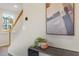 Inviting entryway with neutral walls and decorative art, leading to a stairway with white railings at 279 Providence Creek Dr, Fuquay Varina, NC 27526