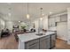 Open-concept kitchen featuring a large island, stainless steel appliances, and modern finishes at 279 Providence Creek Dr, Fuquay Varina, NC 27526