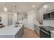 Modern kitchen features gray cabinets, an island with seating, and stainless steel appliances at 279 Providence Creek Dr, Fuquay Varina, NC 27526