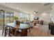 Open concept living room and dining room with sliding glass doors to screened porch and view of backyard at 279 Providence Creek Dr, Fuquay Varina, NC 27526