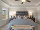 Elegant main bedroom featuring a trey ceiling, a padded headboard, and decorative lamps on bedside tables at 279 Providence Creek Dr, Fuquay Varina, NC 27526