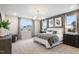 Spacious main bedroom with a large window, stylish decor, and a comfortable seating area at 279 Providence Creek Dr, Fuquay Varina, NC 27526