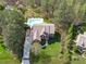 Stunning aerial view of a property with a pool, lush greenery, and charming home exterior at 2909 Timpani Trl, Apex, NC 27539