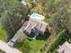 Aerial view of home highlighting manicured lawn, in-ground pool, and surrounding greenery at 2909 Timpani Trl, Apex, NC 27539
