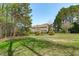Back exterior showcasing a well-maintained lawn and a screened-in porch for relaxing at 2909 Timpani Trl, Apex, NC 27539
