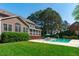 Beautiful backyard with pool, mature landscaping, and a screened in porch providing additional living space at 2909 Timpani Trl, Apex, NC 27539