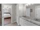 En-suite bathroom featuring double sinks, granite countertops, with a bedroom view at 2909 Timpani Trl, Apex, NC 27539