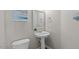Cozy half-bath features a pedestal sink and modern fixtures at 2909 Timpani Trl, Apex, NC 27539