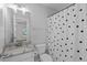 Bright bathroom features granite counters, a shower with a polka dot curtain, and neutral wall colors at 2909 Timpani Trl, Apex, NC 27539