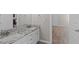 En-suite bathroom with double vanity, granite countertops, and a glimpse into the bedroom at 2909 Timpani Trl, Apex, NC 27539