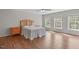 Spacious bedroom features hardwood floors, three windows providing natural light, and a ceiling fan at 2909 Timpani Trl, Apex, NC 27539