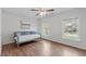 Inviting bedroom showcases hardwood floors, two windows, and a comfortable daybed for lounging at 2909 Timpani Trl, Apex, NC 27539
