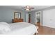 Cozy bedroom with hardwood floors, offering a glimpse into an en-suite bathroom at 2909 Timpani Trl, Apex, NC 27539