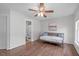 Bright bedroom featuring hardwood floors, a daybed, and connecting access to a bathroom at 2909 Timpani Trl, Apex, NC 27539