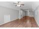 Large bonus room with hardwood floors, neutral paint, ceiling fans, and ample lighting at 2909 Timpani Trl, Apex, NC 27539
