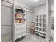 Well-organized walk-in closet with shelves, drawers, and hanging rods for ample storage at 2909 Timpani Trl, Apex, NC 27539