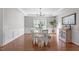 Bright dining room with hardwood floors, chandelier, and wainscoting at 2909 Timpani Trl, Apex, NC 27539
