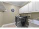 Functional laundry room with white cabinets, washer, and dryer at 2909 Timpani Trl, Apex, NC 27539
