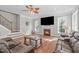 Bright living room with hardwood floors, fireplace and comfortable seating at 2909 Timpani Trl, Apex, NC 27539