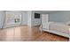 Serene main bedroom with a large window and hardwood flooring at 2909 Timpani Trl, Apex, NC 27539